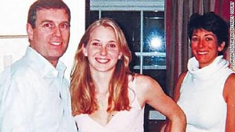 A photo that appears to show Prince Andrew with Jeffrey Epstein's prosecutor Virginia Roberts Giuffre and Ghislaine Maxwell in the background.