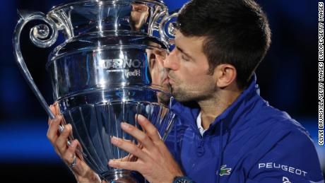 Novak Djokovic receives the trophy for closing the year as the world's number 1.