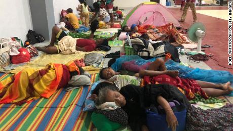 Residents sleep on Dec. 16 in a sports complex converted into an evacuation center in the city of Dapa, Surigao, in the Philippines.