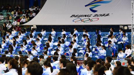 Beijing University volunteers attend a ceremony ahead of the 2022 Winter Olympics in Beijing on January 20.