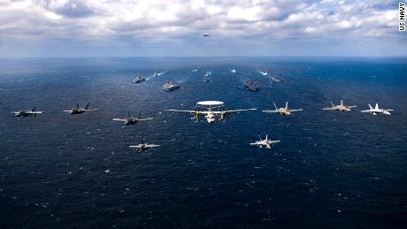 Planes fly over a US-Japanese naval fleet carrying two US aircraft carriers in the Philippine Sea on Saturday.