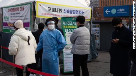 Members of the public wait in line at a temporary Covid-19 testing station set up outside Seoul station on March 4, 2022.