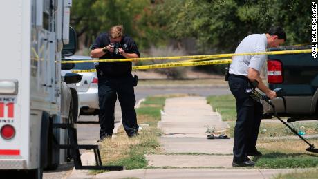 In this photo from August 28, 2015, members of the Bexar County Sheriff's Department investigate the scene where Gilbert Flores was fatally shot.
