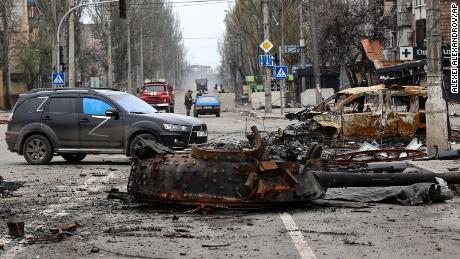 Part of a destroyed tank and a burned vehicle are pictured in an area controlled by Russian-backed separatist forces on April 23 in Mariupol.