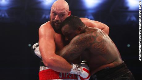 Fury holds Dillian Whyte during the fight. 