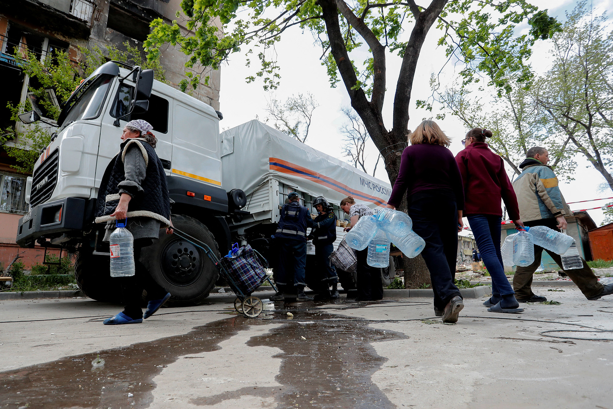 Local residents gather near a tanker to collect drinking water in Mariupol, Ukraine, on May 11.
