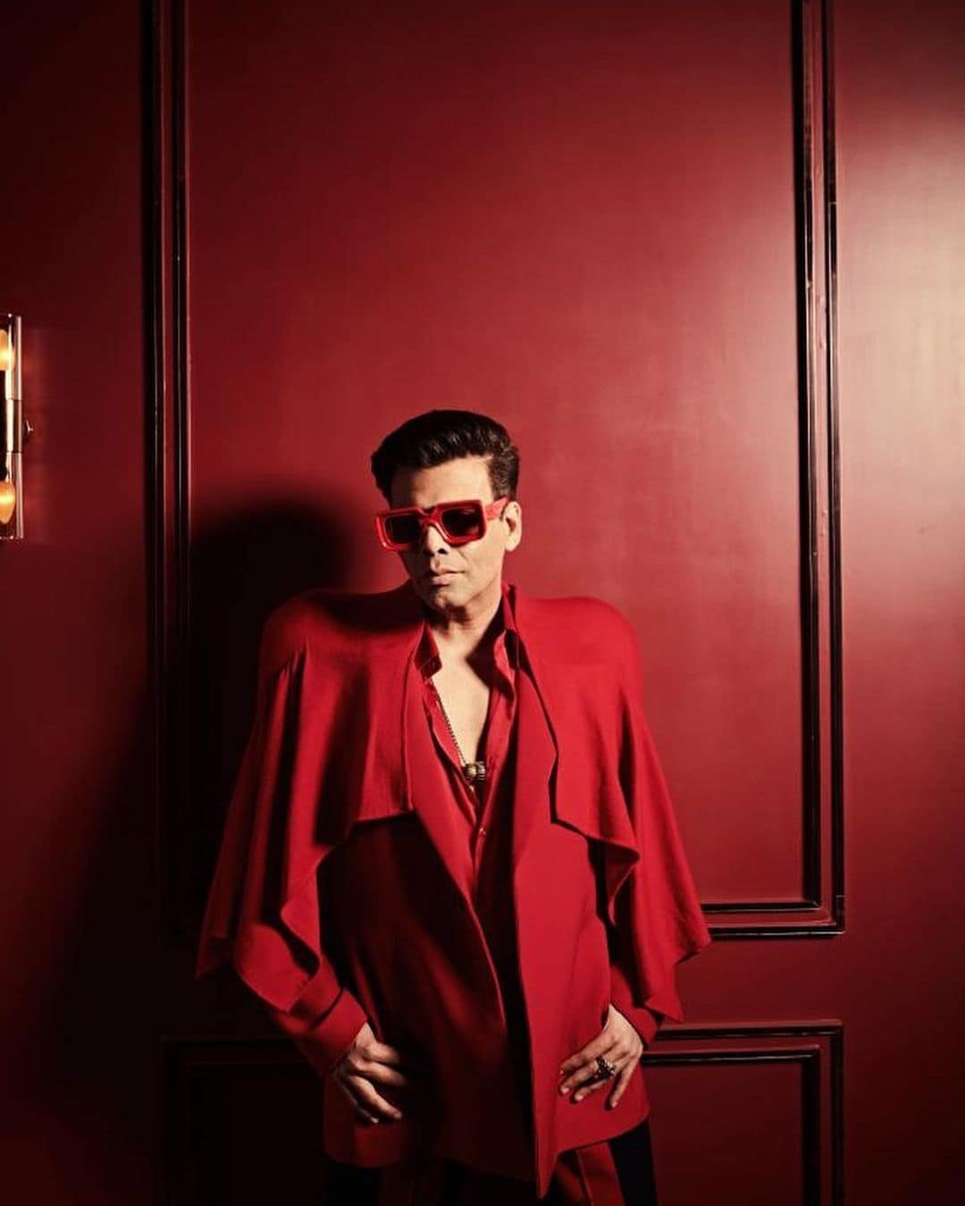 Karan Johar likes to experiment with his looks. This custom Kaushik Velendra handmade power shoulder suit in red is what Karan Johar's style is all about.