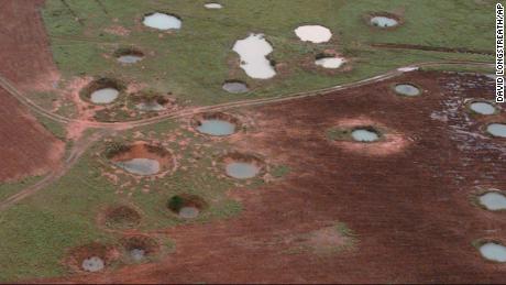 What appear to be ponds are actually water-filled bomb craters from the Vietnam War era, viewed from a helicopter, May 25, 1997, near the northeastern Laotian village of Sam Neau.