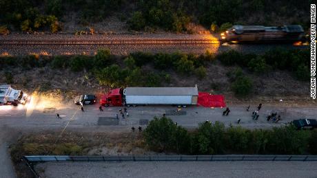 Law enforcement officers investigate the tractor-trailer on June 27, 2022 in San Antonio, Texas. 