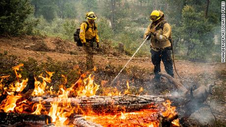 Firefighters mop hot spots as they battle California's Oak Fire.