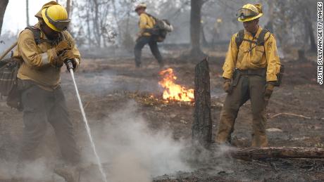 Firefighters work to contain the hot spots from the Oak Fire, which started burning Friday.