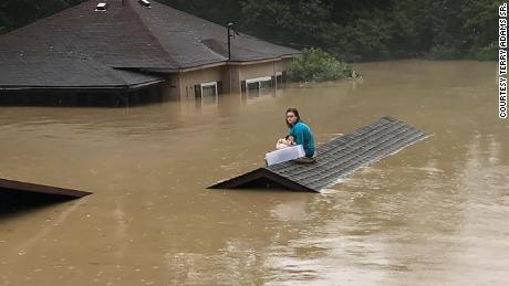A 17-year-old swam out of her flooded house with her dog and waited hours on a roof to be rescued