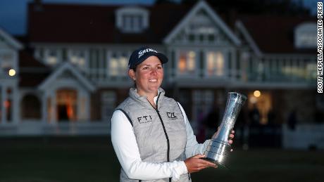 Buhai holds the trophy after her win.