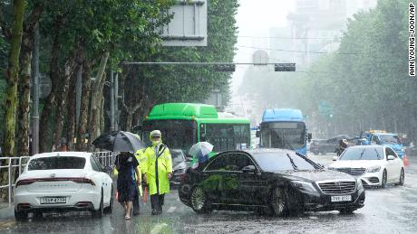 Vehicles flooded by torrential rains blocked a road in Seoul, South Korea, on Aug. 9.