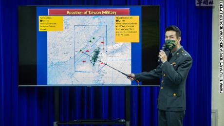 A Taiwanese major points to a map of recent drone raids.